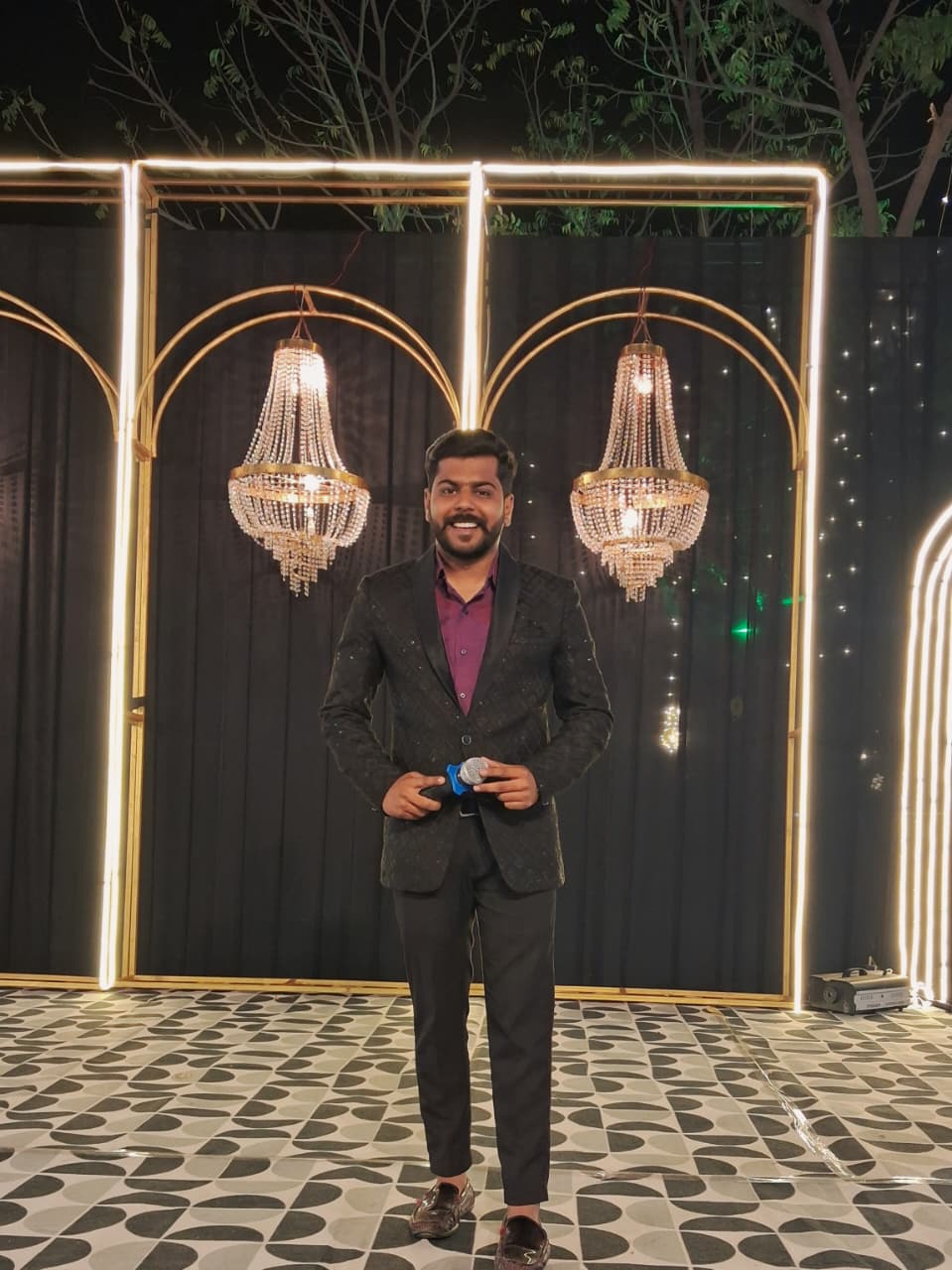 Anchor Himanshu Paliwal at an evening celebration backdrop